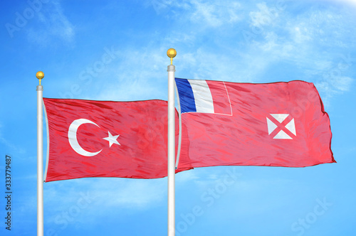 Turkey and Wallis and Futuna two flags on flagpoles and blue cloudy sky photo