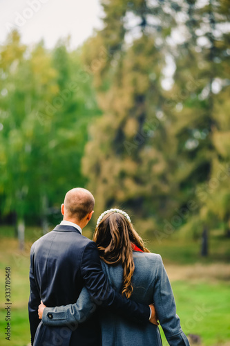 A guy and a girl hugging look at the park