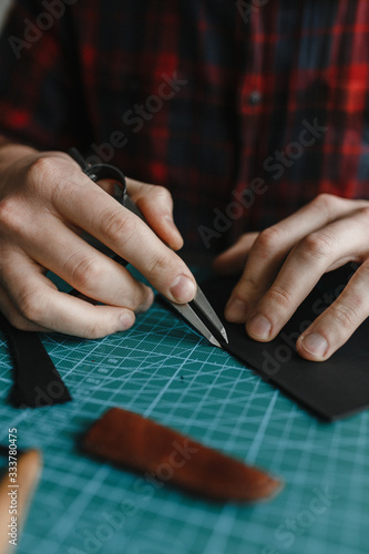 Man hands working with the leather shred photo