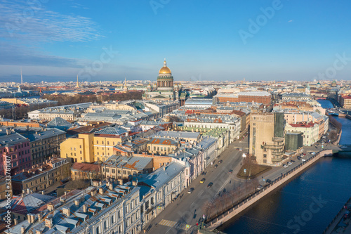 St. Isaac's Cathedral in the distance above the rooftops of the city of Saint-Petersburg, view heights of the Moika River and the old urban panorama.