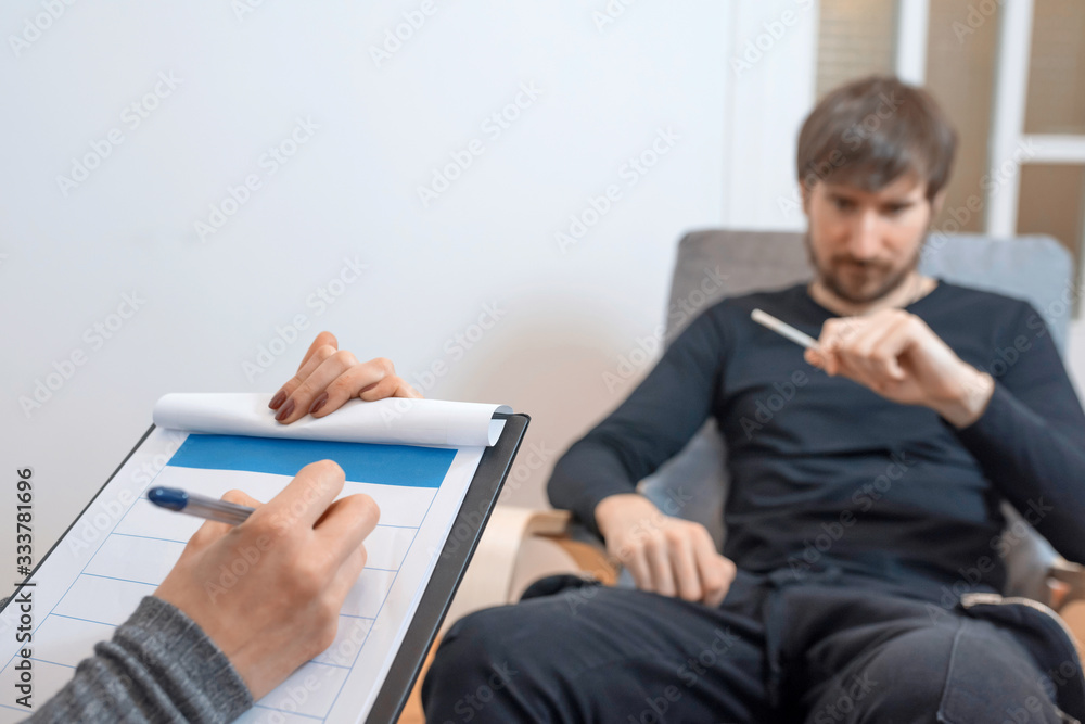 A man at a consultation in a psychologists office. Emotional health problems. A man at a consultation in a psychologists office. Emotional health problems.