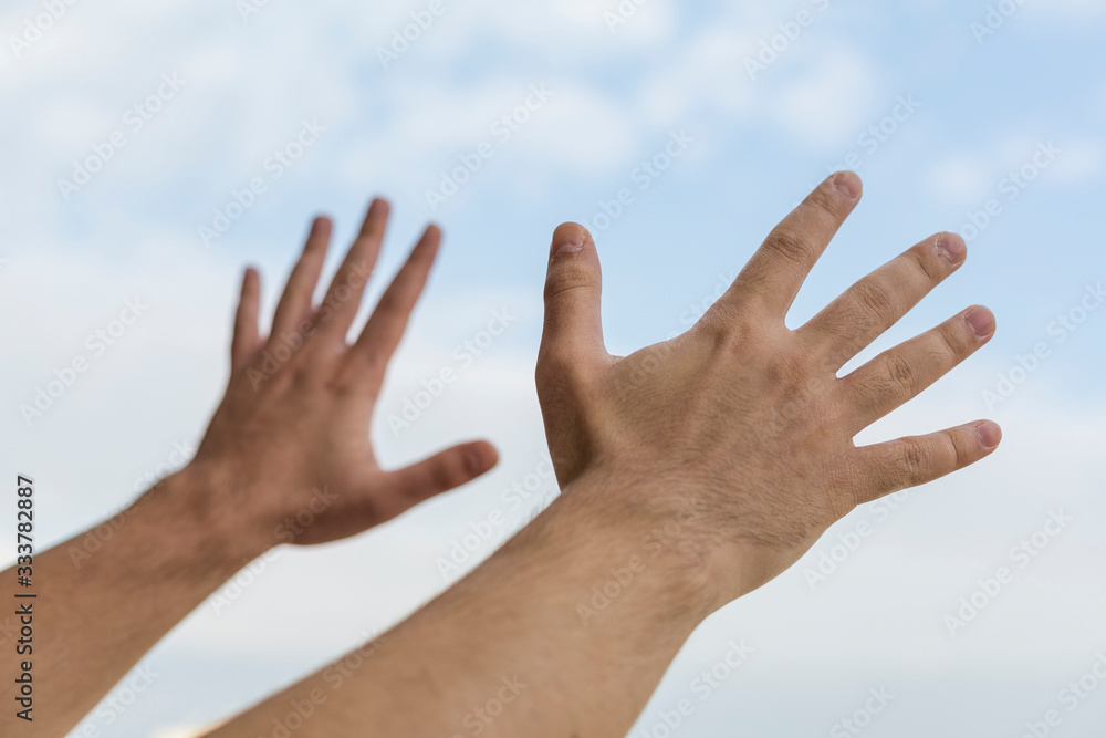 Human hands stretched out in the sky Human hands stretched out in the sky