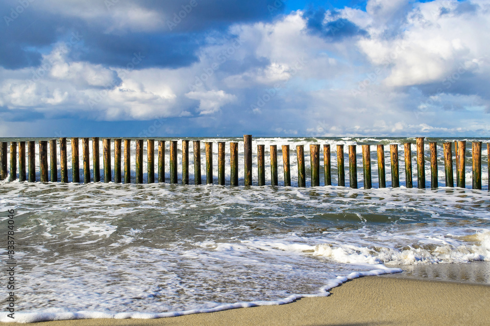 Wooden breakwater at the coast of the sea