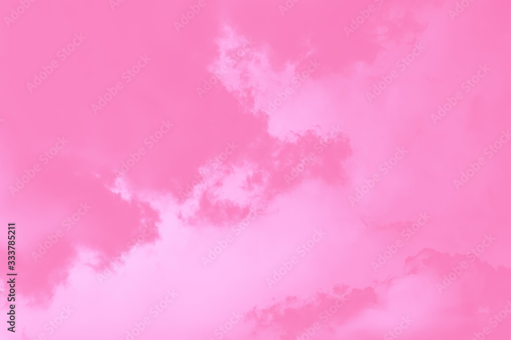 Pastel sky background. Pink sky with fluffy clouds