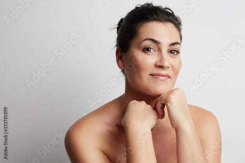 Dark hair beautiful woman posing on the white background. Horizontal.