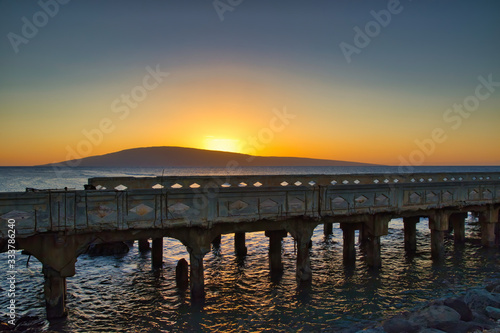 Sunset at Mal Pier towards the ocean and Lanai. © manuel