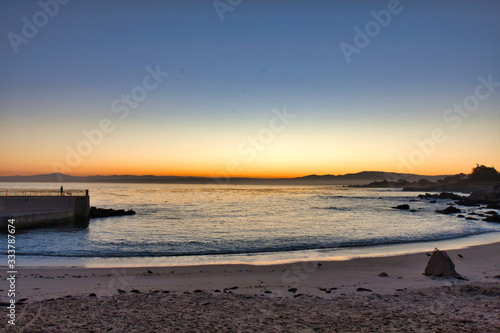 Tranquil sunrise scene at Pacific Gove Beach on the Monterey Peninsula. © manuel