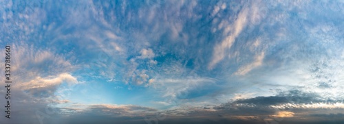 Fantastic clouds against blue sky, panorama