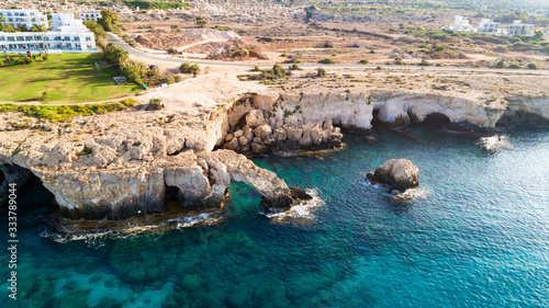 Aerial bird's eye view of Love bridge, international sculpture park and sea caves, at Cavo Greco, Ayia Napa, Famagusta, Cyprus from above. Tourist attraction cliff rock arch in Ammochostos from above.