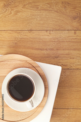 Cup of coffee on wooden background. Top view.