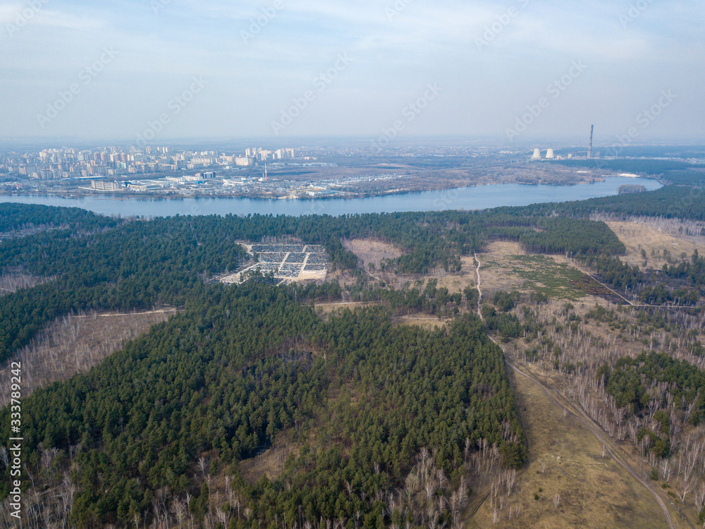 A lake near a coniferous forest on the outskirts of Kiev. Aerial drone view.