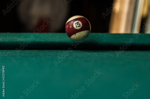 Billiards balls and cue on billiards table. Billiard sport concept.Ball in motion