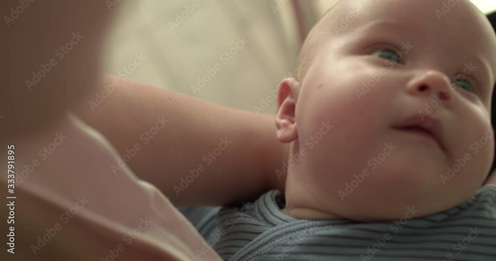 Portrait of cute newborn looking around and crying on mother's hands Portrait of cute newborn looking around and crying on mother's hands