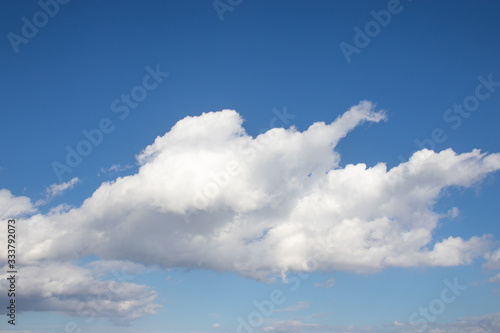White fluffy clouds on bright blue sky