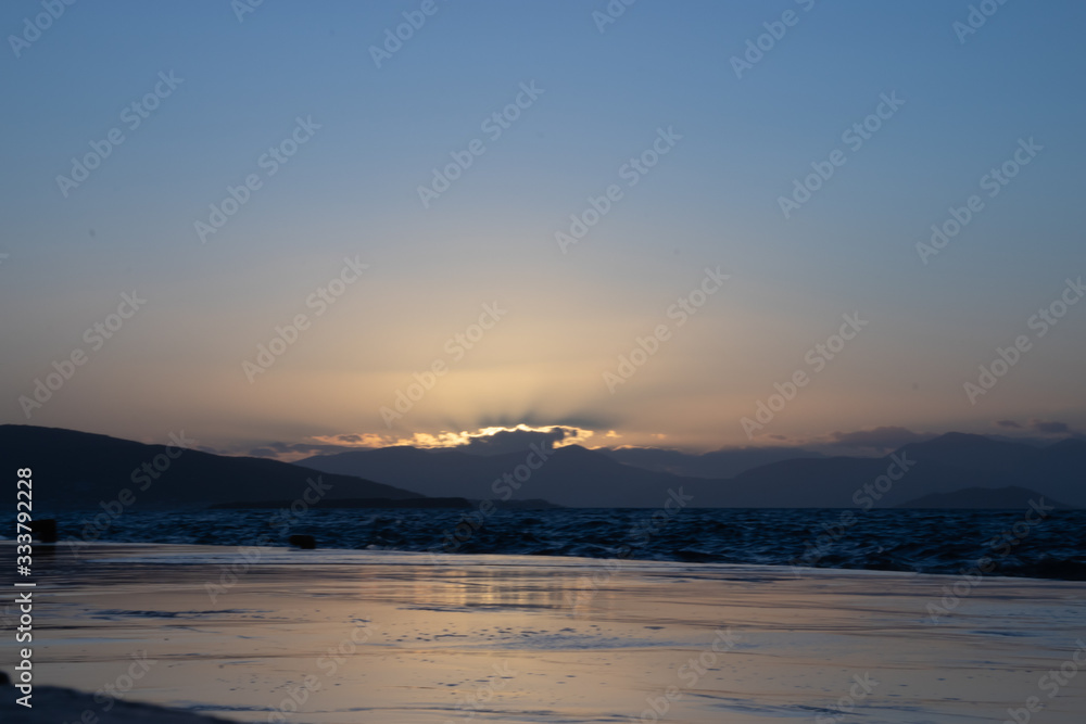 Sunset on aegina island in greece with clouds
