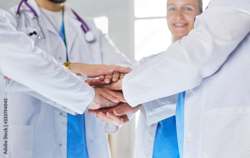 Doctors and nurses in a medical team stacking hands Doctors and nurses in a medical team stacking hands