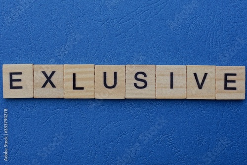 word exlusive made from gray letters lies on a blue background