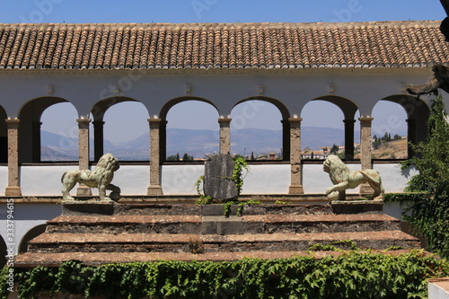 Court of the Sultana’s Cypress Tree (Patio de la Sultana) with two lion statues at Generalife gardens at Alhambra palace and fortress complex in Granada, Andalusia, Spain.