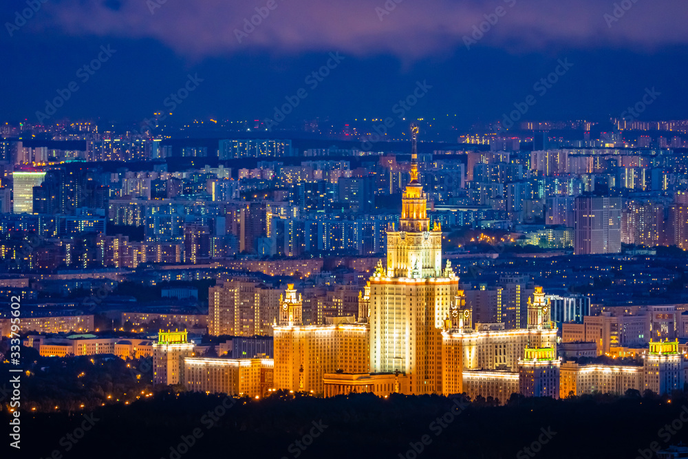 Moscow. Russia. Night panorama of Moscow. Capital aerial view. Lights of the night city. Moscow State University glows at night. Seven sisters. Russian architecture. City landscape. Cities of Russia
