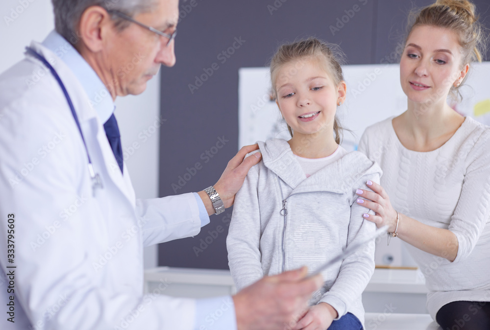 Little girl with her mother at a doctor on consultation Little girl with her mother at a doctor on consultation