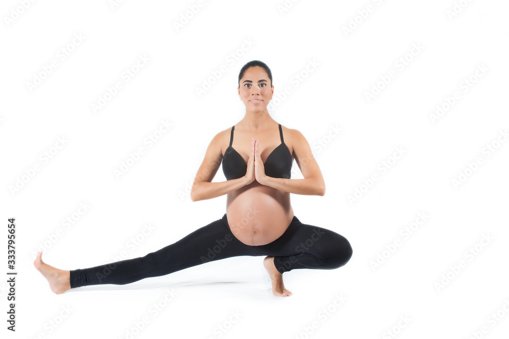 Pregnant woman making a Yoga exercise Pregnant woman making a Yoga exercise