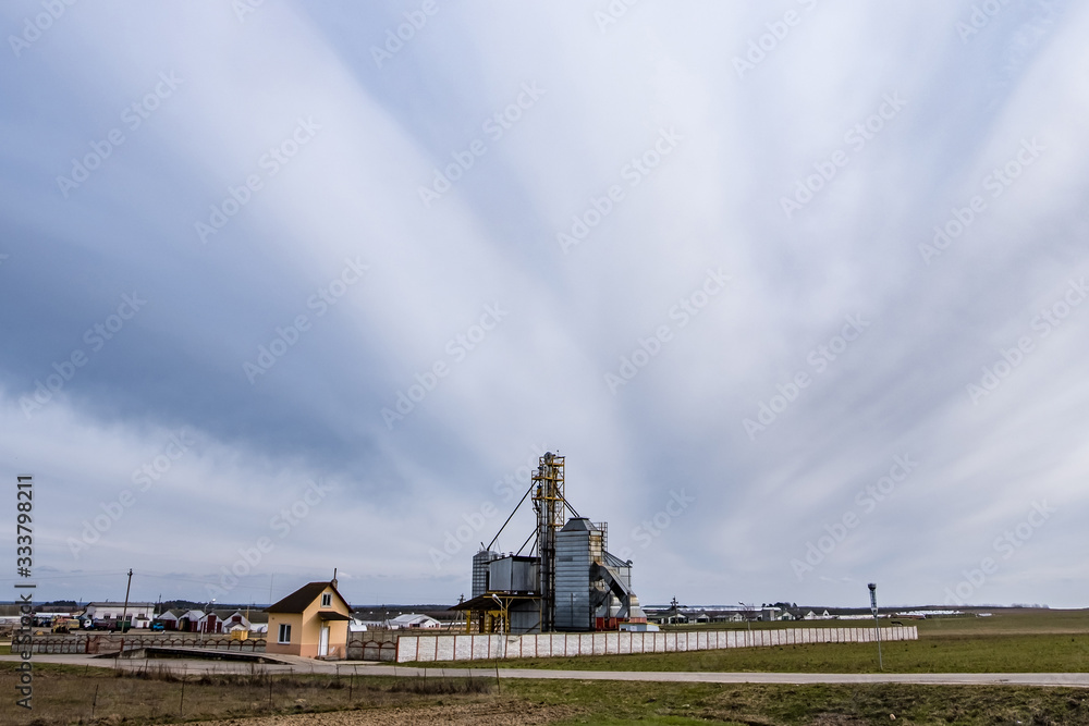Fototapeta premium agro-processing and manufacturing plant for processing and silver silos for drying cleaning and storage of agricultural products, flour, cereals and grain. Granary elevator.