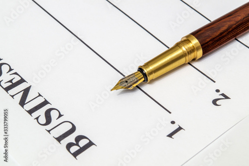 Stylish a pen lies on a business plan form in front of notes