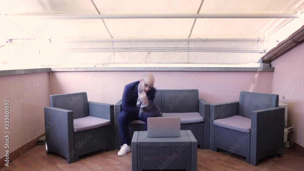 Time lapse of Businessman in blue suit that works on his laptop, typing and working on outdoor desk. He has a problem and want to solve it. Time lapse of Businessman in blue suit that works on his laptop, typing and working on outdoor desk. He has a problem and want to solve it.