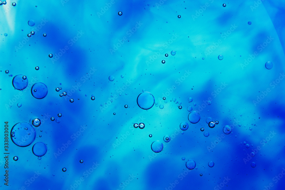 drops of oil on water and colorful blurred background drops of oil on water and colorful blurred background