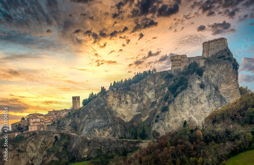 Fototapeta Sunset view of San Leo fortress on a hilltop with cannon towers in Italy