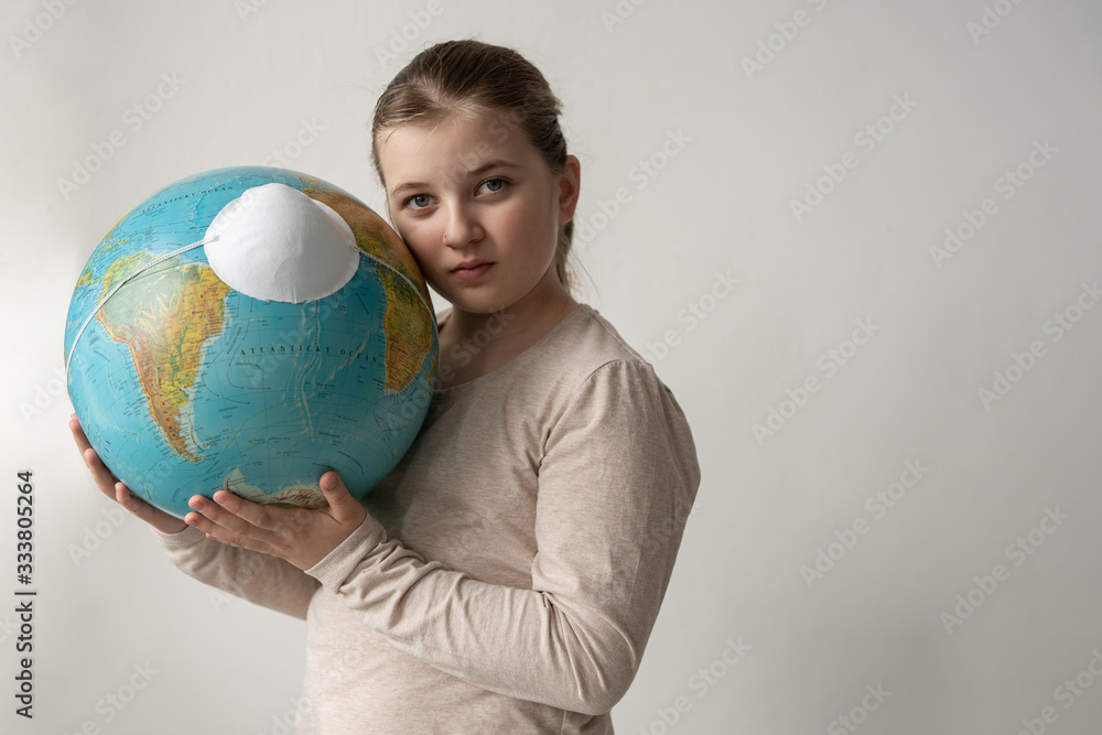 girl holding worl model globe with face virus protection mask respirator agains white background girl holding worl model globe with face virus protection mask respirator agains white background