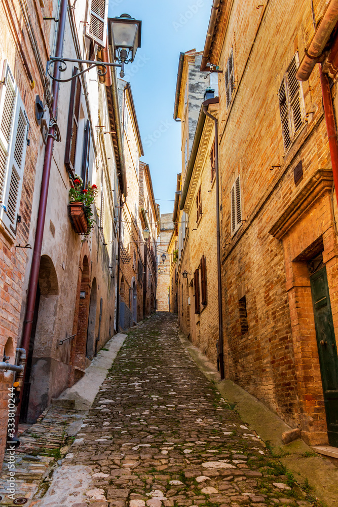View of a beautiful narrow steep street in Fermo, Province of Fermo, Marche Region, Italy