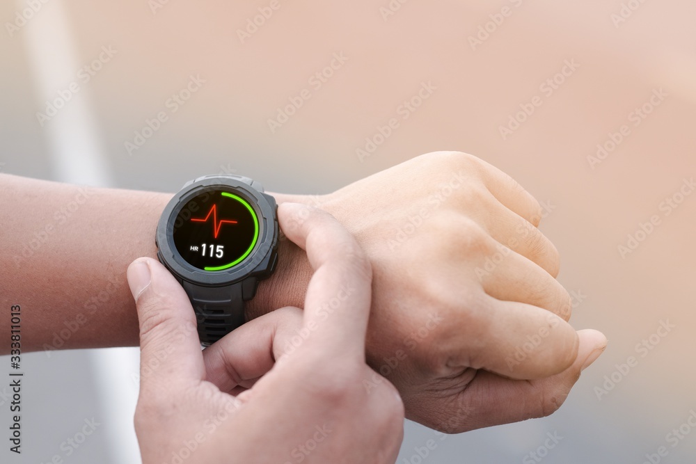 A man using smart watch for tracking running