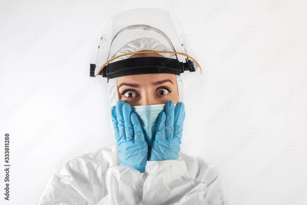 Isolated virus scare caucasian woman in medical uniform and face mask. Concept of covid-19 and Asian flu panic.