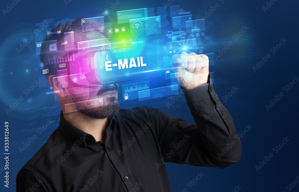 Businessman looking through Virtual Reality glasses with E-MAIL inscription, innovative security concept Businessman looking through Virtual Reality glasses with E-MAIL inscription, innovative security concept