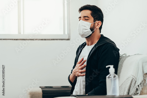 Coronavirus, covid-19 and quarantine concept. Sick man with shortness of breath symptom photo
