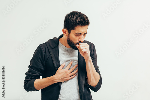 Quadro su tela Sick man coughing over his hand. Coronavirus, covid-19 concept