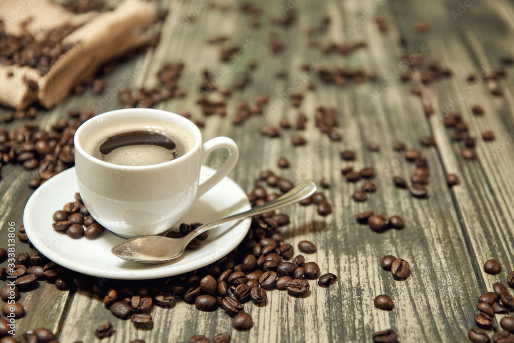 white cup of coffee on retro wooden table white cup of coffee on retro wooden table