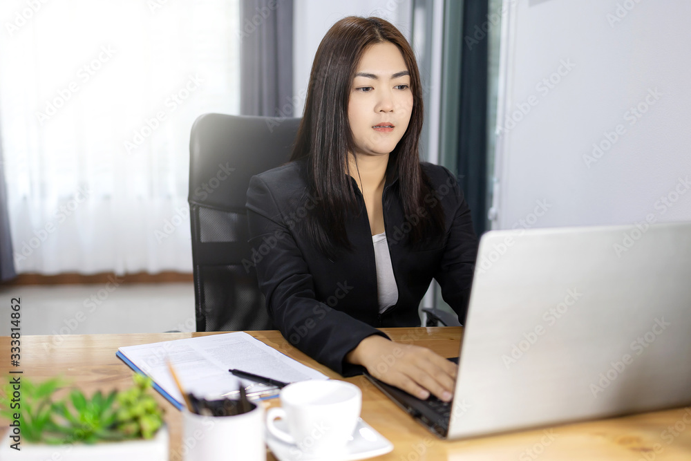 Asian woman working her laptop on desk. Business woman concept in modern office. Asian woman working her laptop on desk. Business woman concept in modern office.