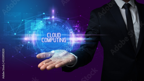 Man hand holding CLOUD COMPUTING inscription, technology concept