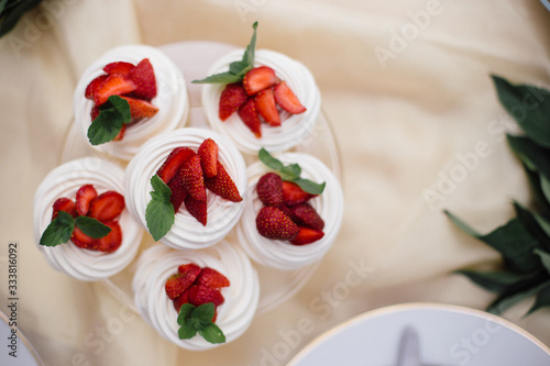 beautiful fruit dessert, fruit cake with strawberries and cream .