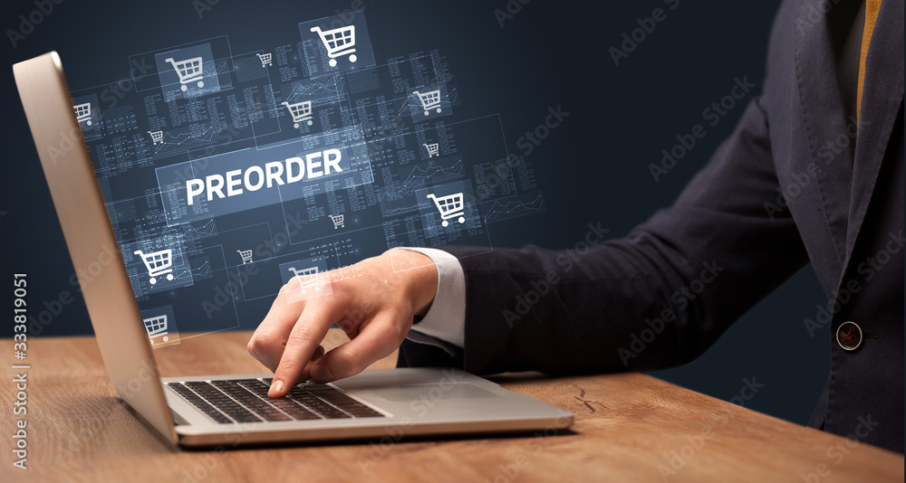 Businessman working on laptop with PREORDER inscription, online shopping concept Businessman working on laptop with PREORDER inscription, online shopping concept