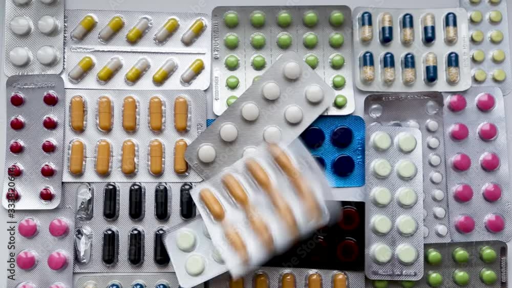 drug packaging thrown out on the background of different pills. A lot of pills in blisters drug packaging thrown out on the background of different pills. A lot of pills in blisters