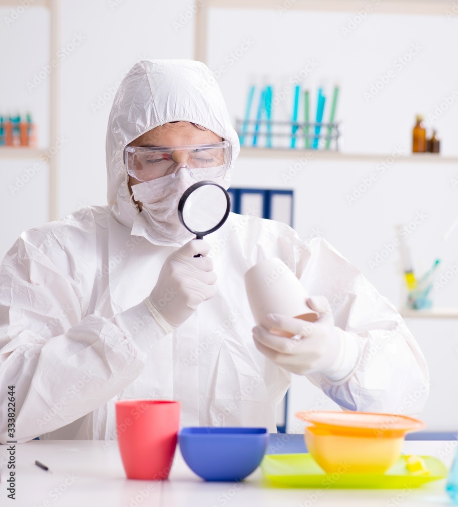 Chemist checking and testing plastic dishes Chemist checking and testing plastic dishes