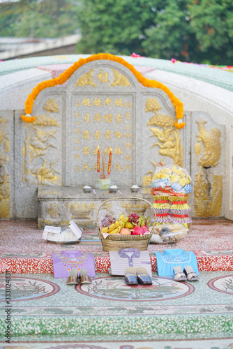 Tomb sweeping day. In Chinese called Qing Ming festival where family would go to their ancester's tomb, cleaning, decorate the tomb with colorful rainbow papers and offering foods. photo