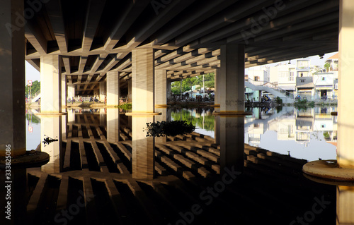 Amazing scene under bridge with reflection wonderful shadow  shape  lines  curve  glean from sunlight on surface water of river