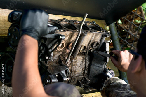 Hands working in a car engine. Cleaning a Car engine. Mechanical Workshop