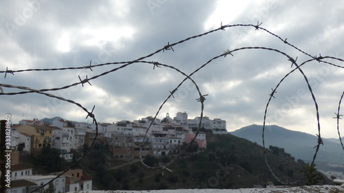 View of village church through barbed wire