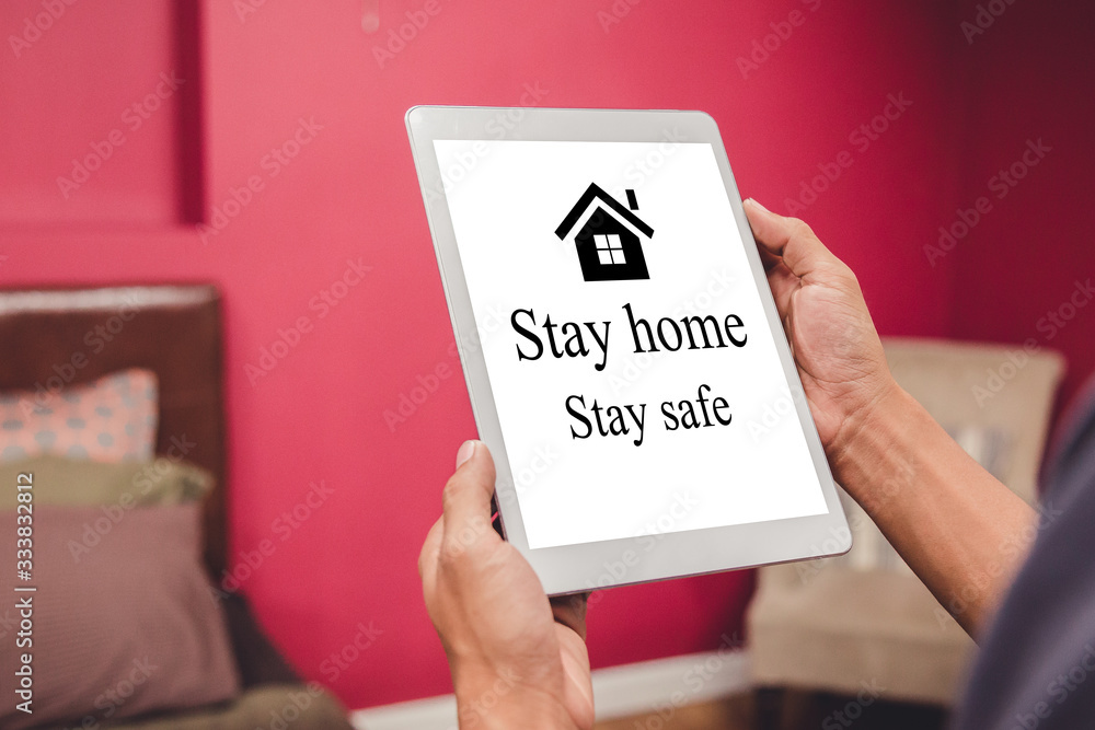 Businessman at home working with tablet,stay at home to reduce risk of infection and spreading the virus. Businessman at home working with tablet,stay at home to reduce risk of infection and spreading the virus.