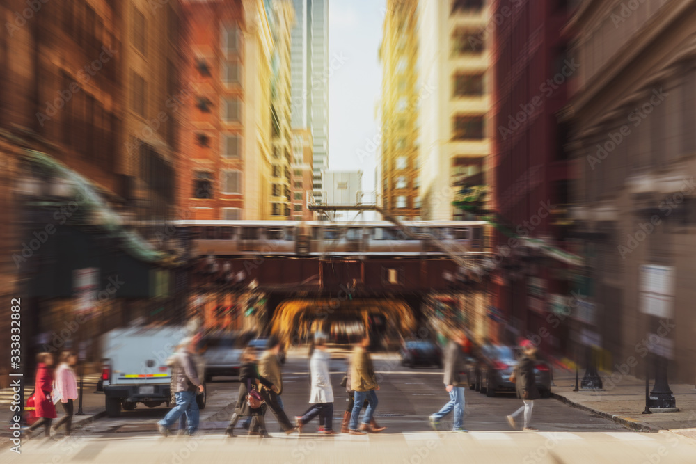Blurred Crowd of Chicago street with traffic road intersection in rush hour among modern buildings of Downtown Chicago at Michigan avenue, Illinois, United States, blur business and people concept